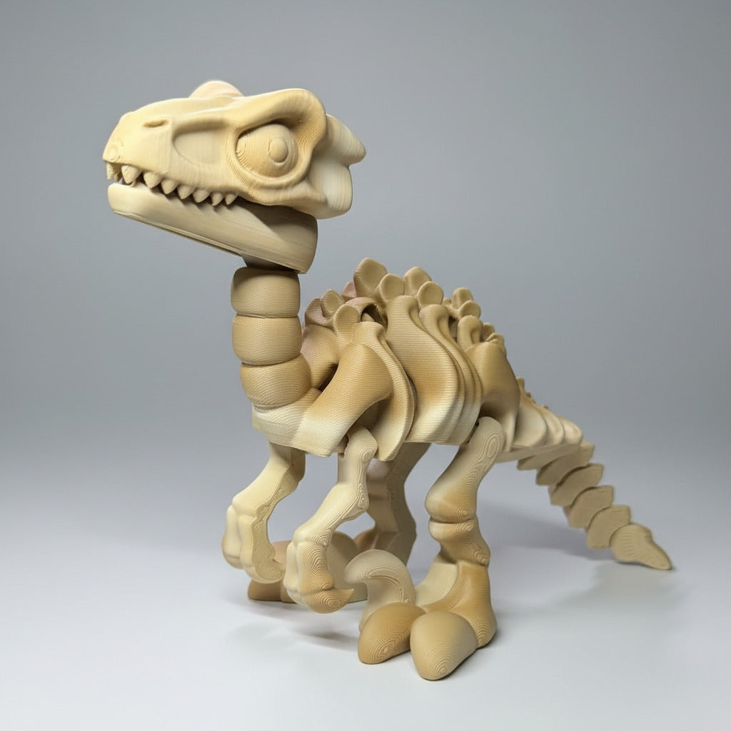 3D-printed dinosaur skeleton model on a blue surface with a 3D printer in the background.